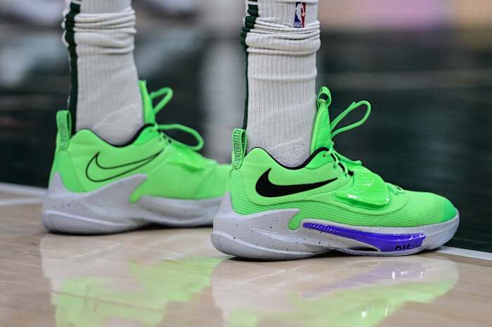 View of Giannis Antetokounmpo's green and grey Nike shoes.